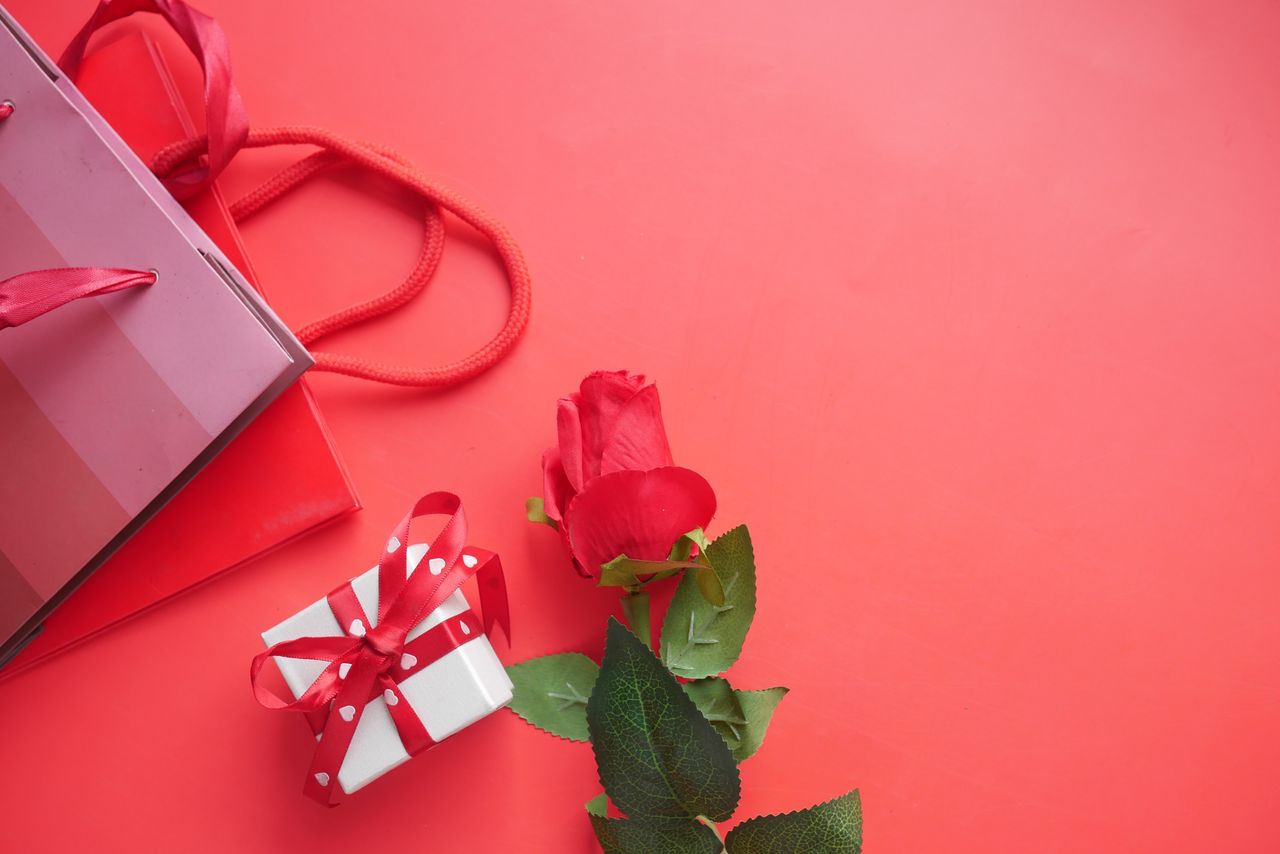 collection-04 Red gift box and rose on a vibrant red background. Perfect for celebrations.