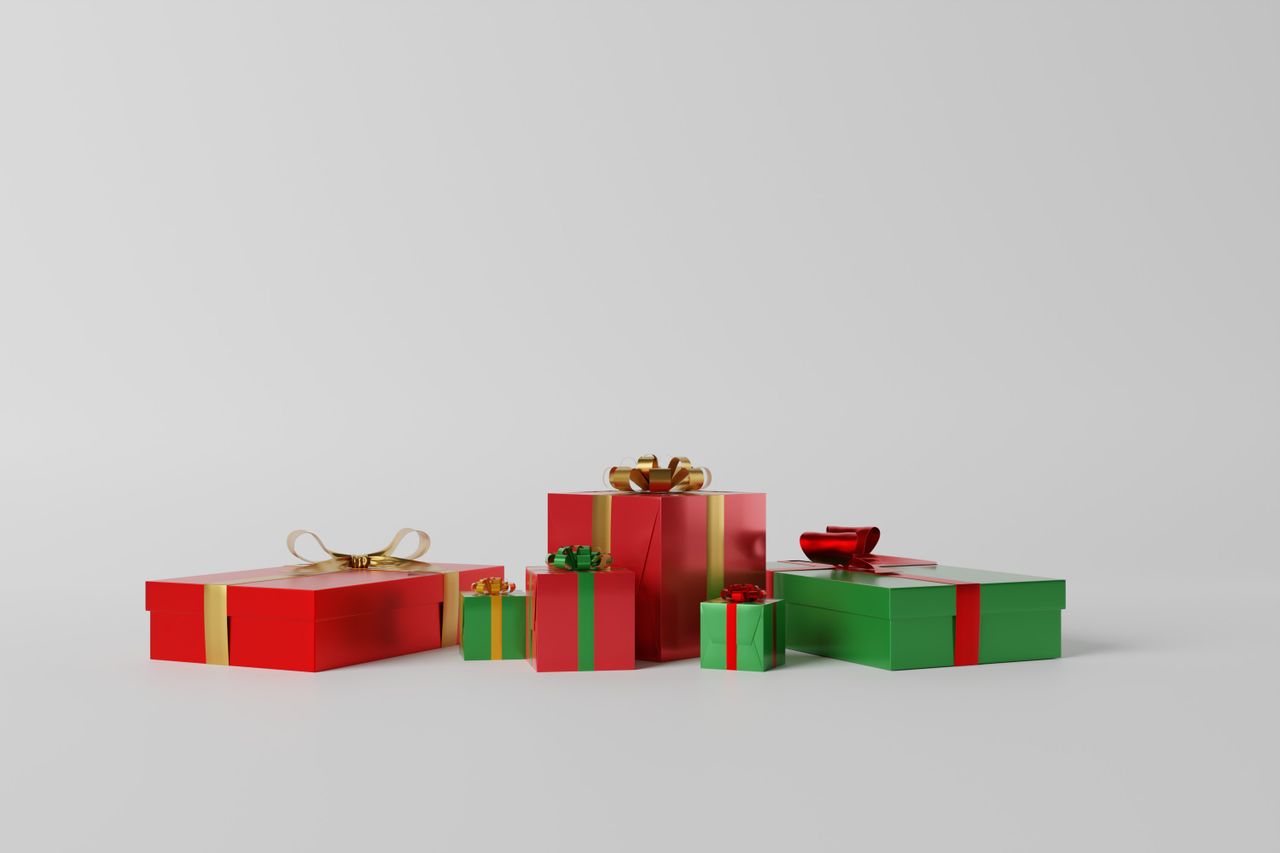 bedroom-bliss A variety of red and green gift boxes with ribbons on a white background, perfect for celebrations.