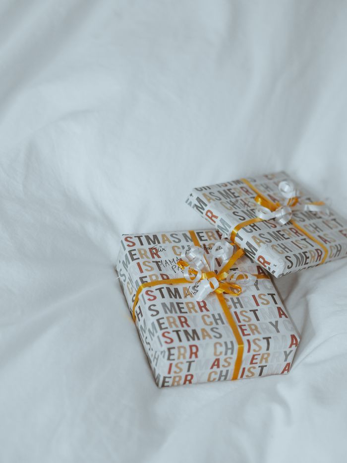 collection-05 Two Christmas gifts wrapped in festive paper and ribbons for a holiday celebration.