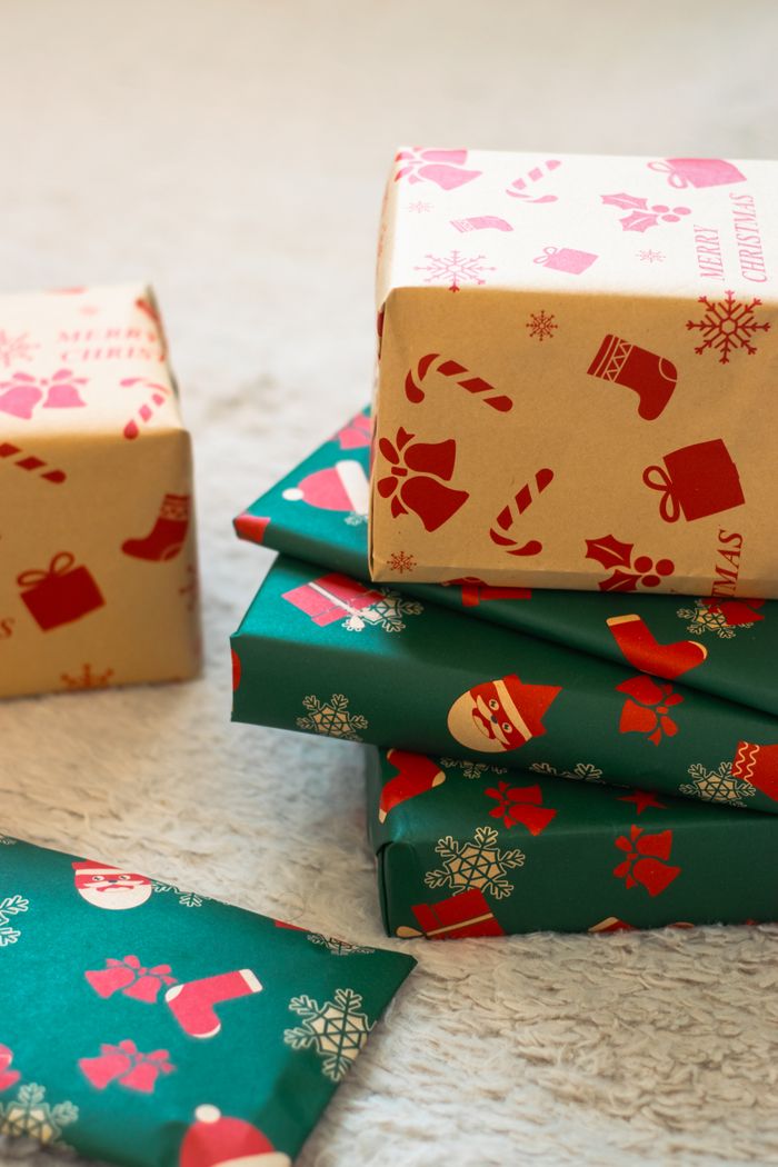 summer-sale Stack of Christmas gifts wrapped in festive paper with holiday designs.